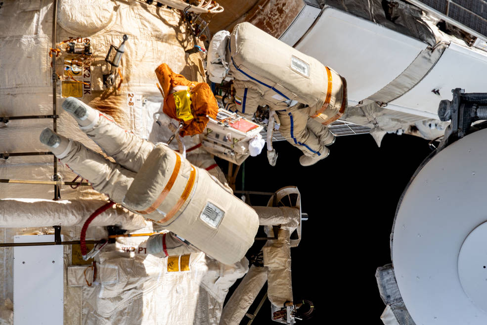 Roscosmos spacewalkers Sergey Prokopyev and Dmitri Petelin work outside the International Space Station's Roscosmos segment during the installation of an experiment airlock on the Nauka multipurpose laboratory module.