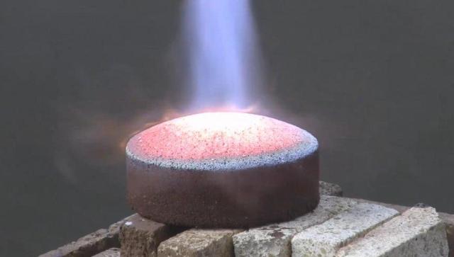 A 2-inch by 4-inch brick is heated by a welding torch in a test of a concept for making heat shields from the soil of other worlds.