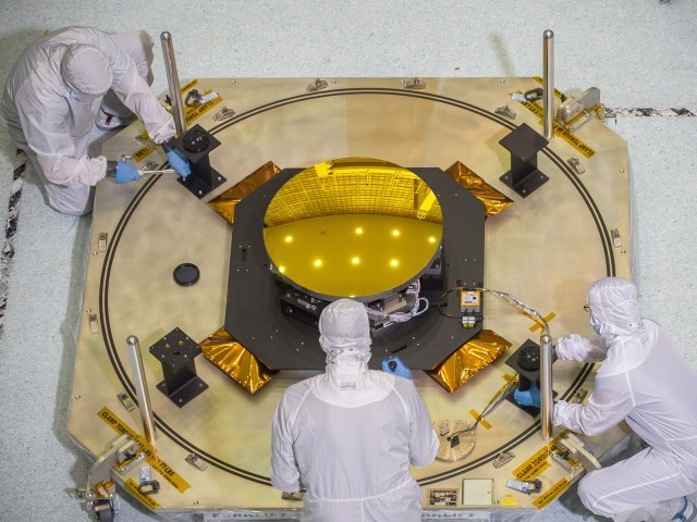 Technicians work with the secondary mirror of the James Webb Space Telescope in a clean room at NASA's Goddard Space Flight Center in Greenbelt, Maryland.