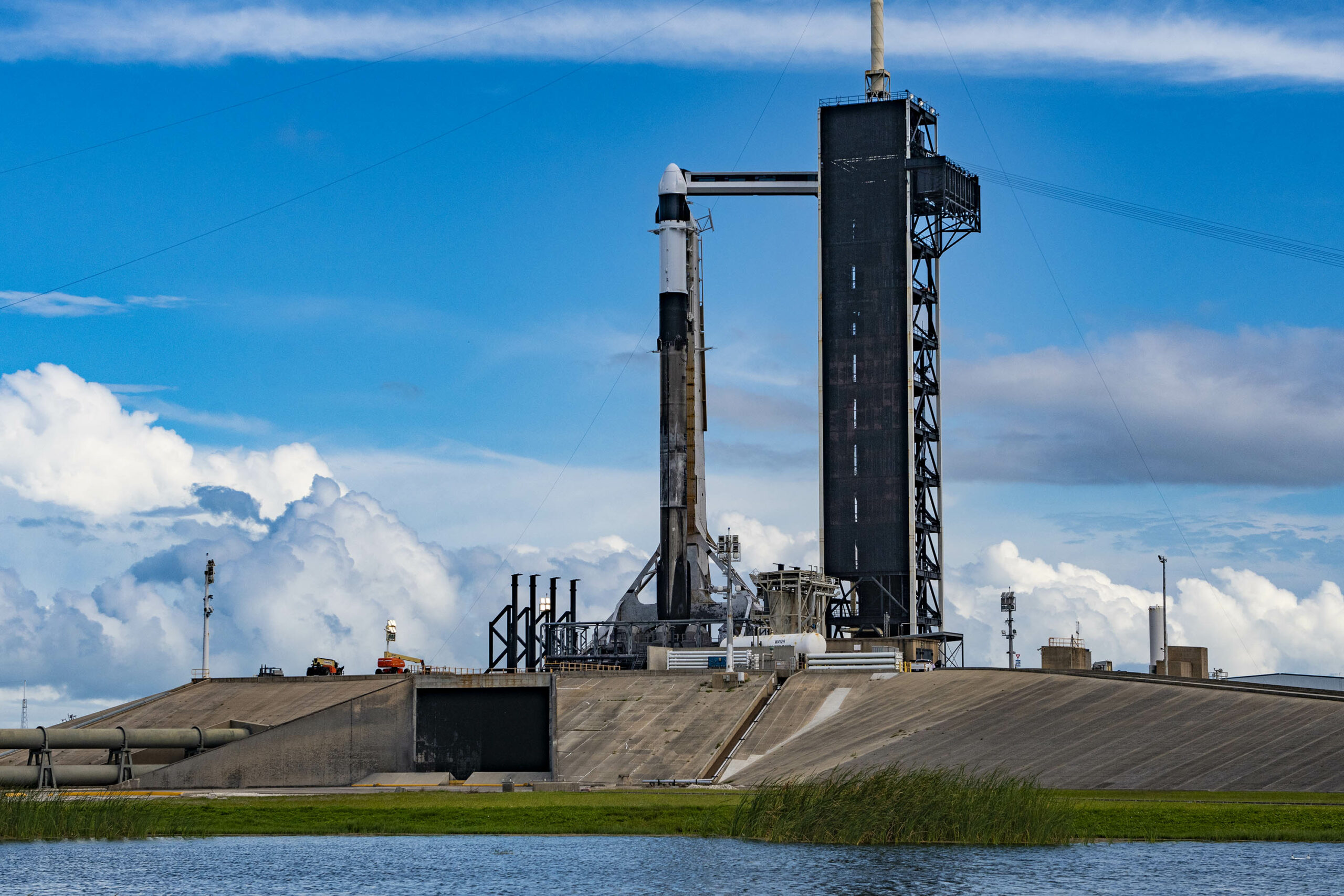 Blue sky and clouds serve as a backdrop for the SpaceX Falcon 9 rocket with the Dragon spacecraft atop on the pad at Launch Complex 39A at NASA’s Kennedy Space Center in Florida on June 2, 2023.