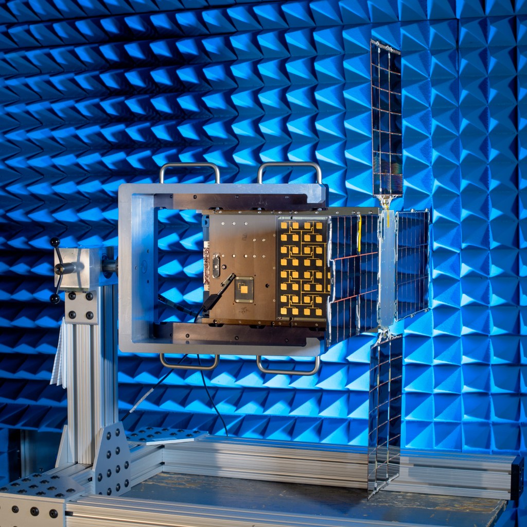 CubeSat in the lab for testing. The craft's solar arrays are open on the right side of the craft.