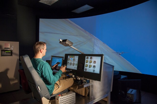 The image representing the Simulator Worksheet A for FlyBy Math shows the X-57 principal investigator Sean Clarke flies the X-57 simulator.