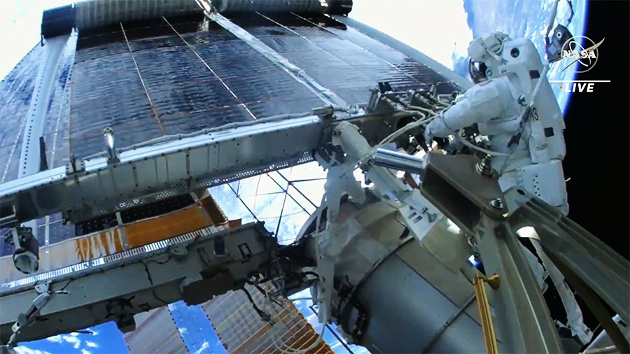 NASA astronaut Woody Hoburg watches as a new solar array deploys after he and fellow NASA spacewalker Stephen Bowen (out of frame) successfully installed it on the space station. Credit: NASA TV