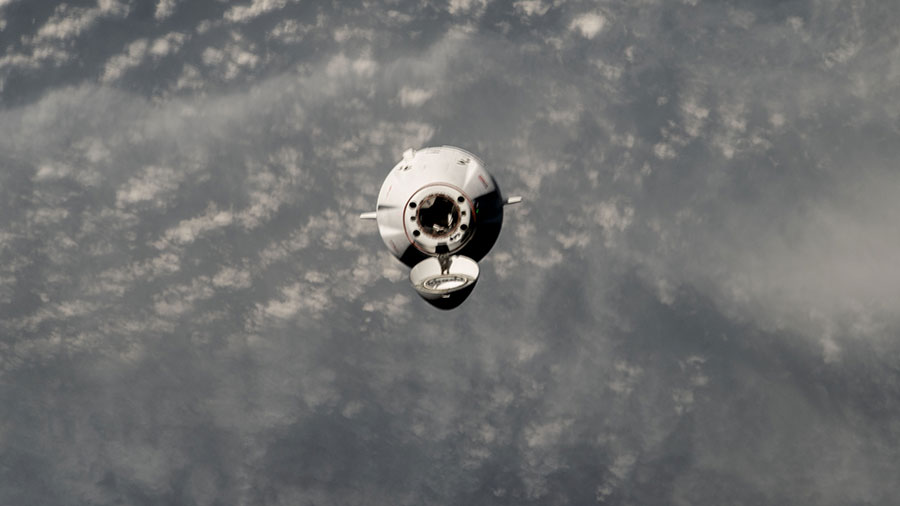 The SpaceX Dragon cargo spacecraft is pictured approaching the International Space Station on June 6 above a cloudy Sea of Japan in this photograph from the orbital outpost.