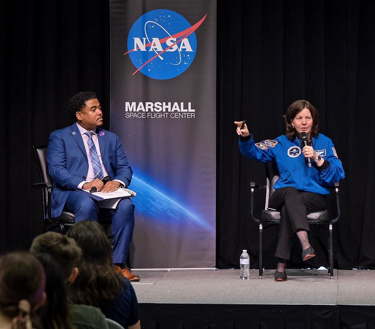 Moderator Lance D. Davis, left, listens as retired NASA astronaut Dr. Cady Coleman, right, speaks to audience members at NASAs Marshall Space Flight Center about her experiences of living and working in space during a panel discussion on June 8.