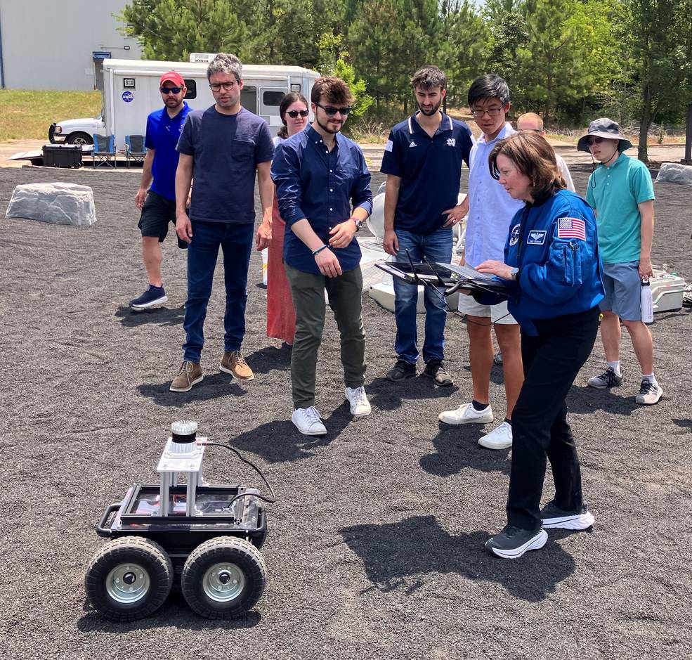 Cady Coleman, retired NASA astronaut, test drives a lunar rover on Marshalls Lunar Regolith Terrain Field during an overview of how the center is developing capabilities for mapping, navigation, mobility on the surface of the Moon.
