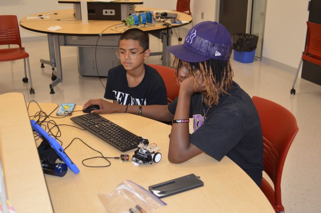 Photo of students programming a robot