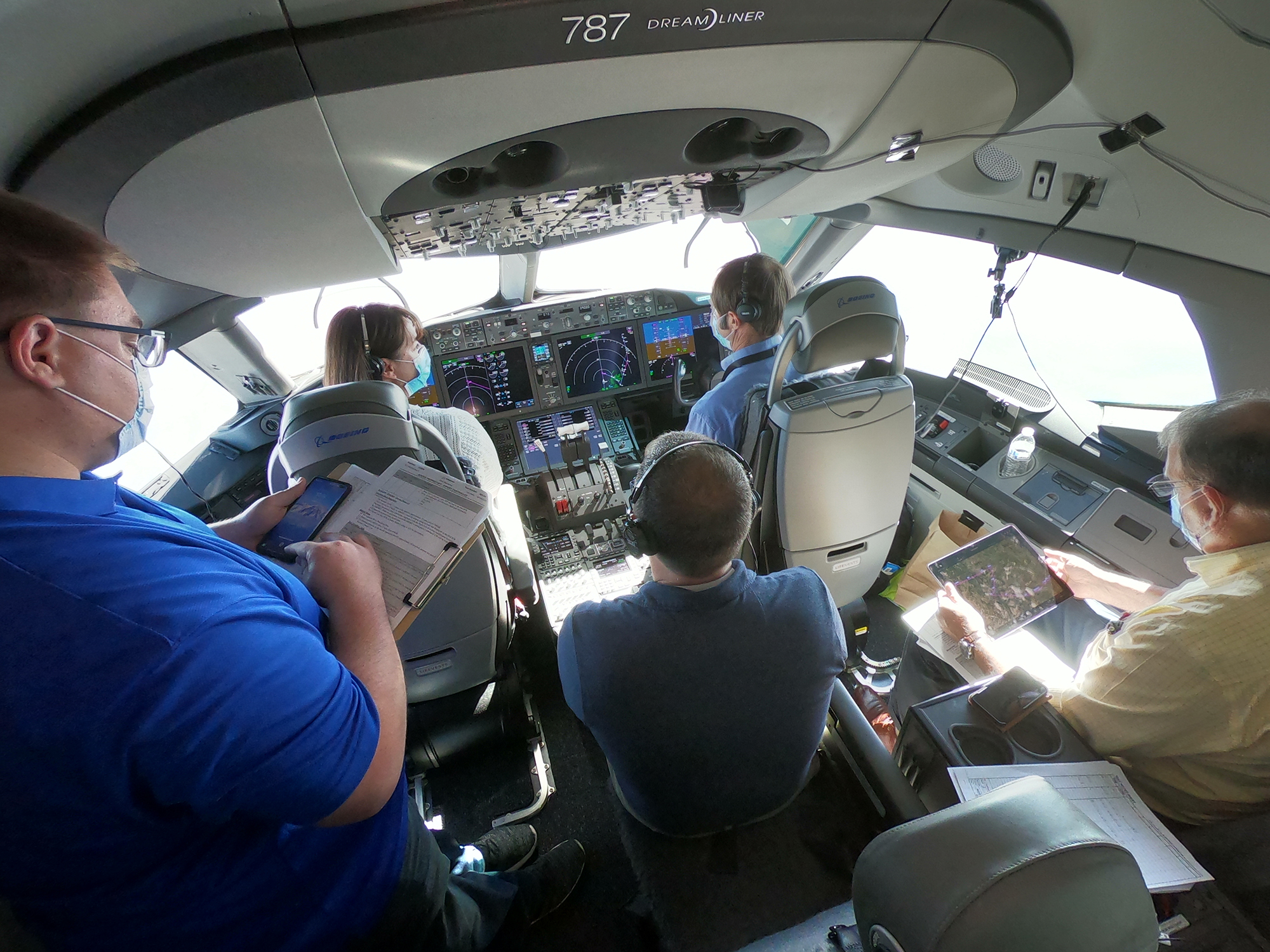 A team of researchers are seen inside the cockpit of a Boeing 787-10.
