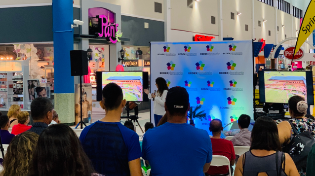 People watch a STEM presentation at the mall