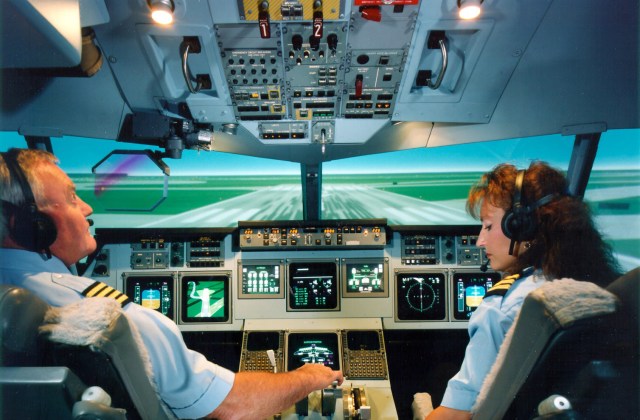 Simulator Worksheet B shows an image of two pilots one male and one female inside an airplane's cockpit.