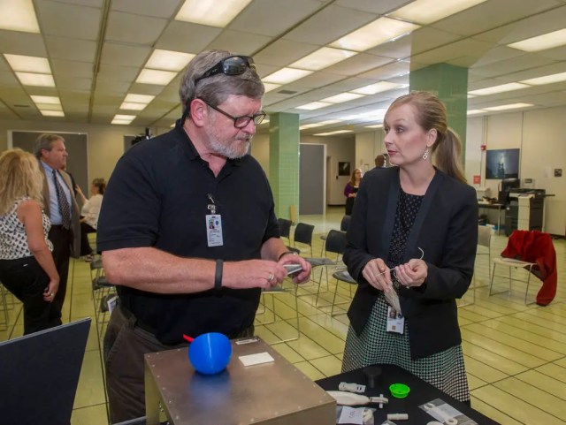 Niki Werkheiser, right, talks with Lee Roop about the 3-D printer targeted for the International Space Station.