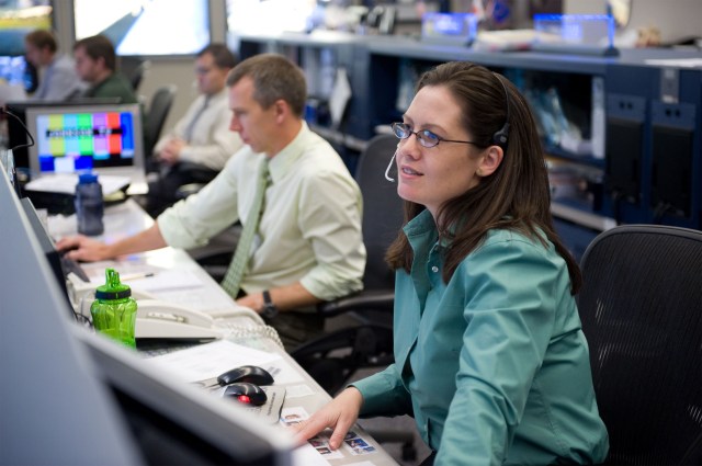 NASA Lead Flight Director Emily Nelson sits on console in the Johnson Space Center Mission Control Center.