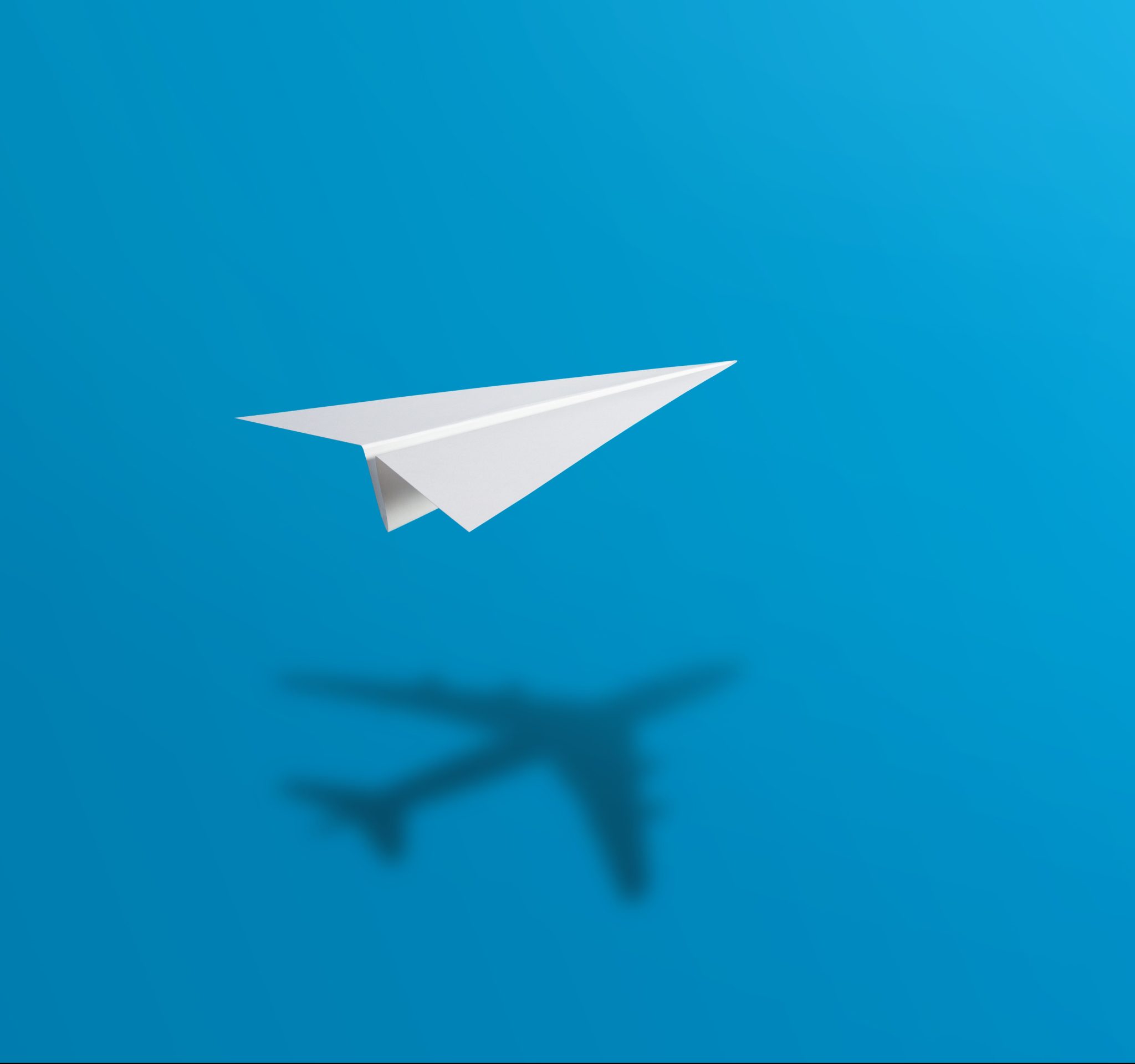 Image of a paper airplane flying on a blue background