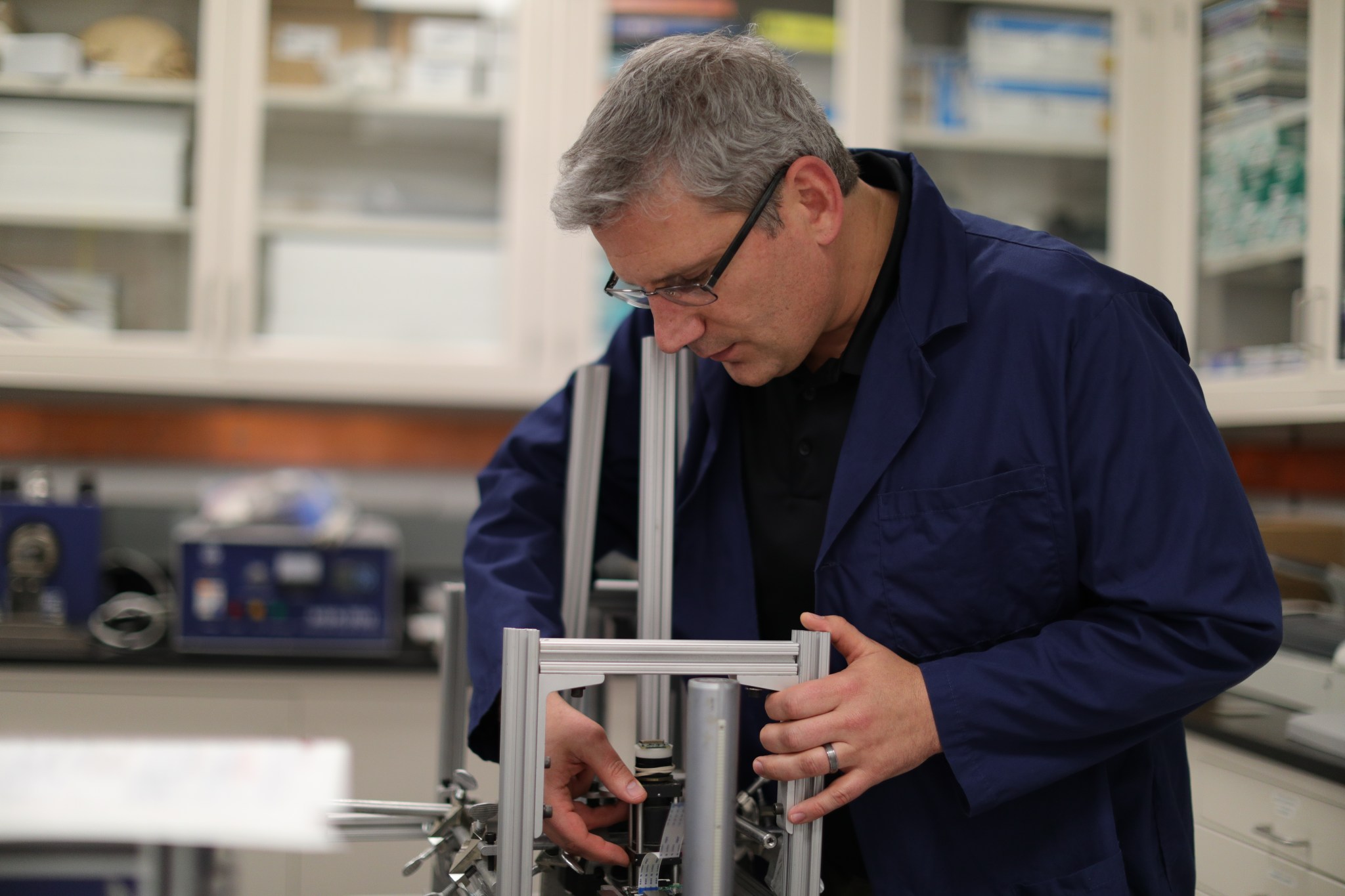 Mike Dupuis, project manager for Electrostatics and Surface Physics Laboratory, is shown working in the lab.
