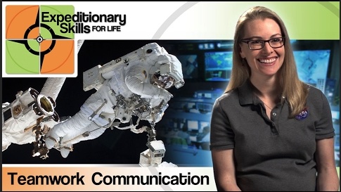 A woman in a NASA polo shirt with the words - Expeditionary Skills, Teamwork Communication with a NASA astronaut in a white spacesuit floating in the background