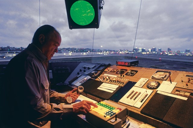 Air Traffic Control Problem 3 image shows a male air traffic controller making a call.