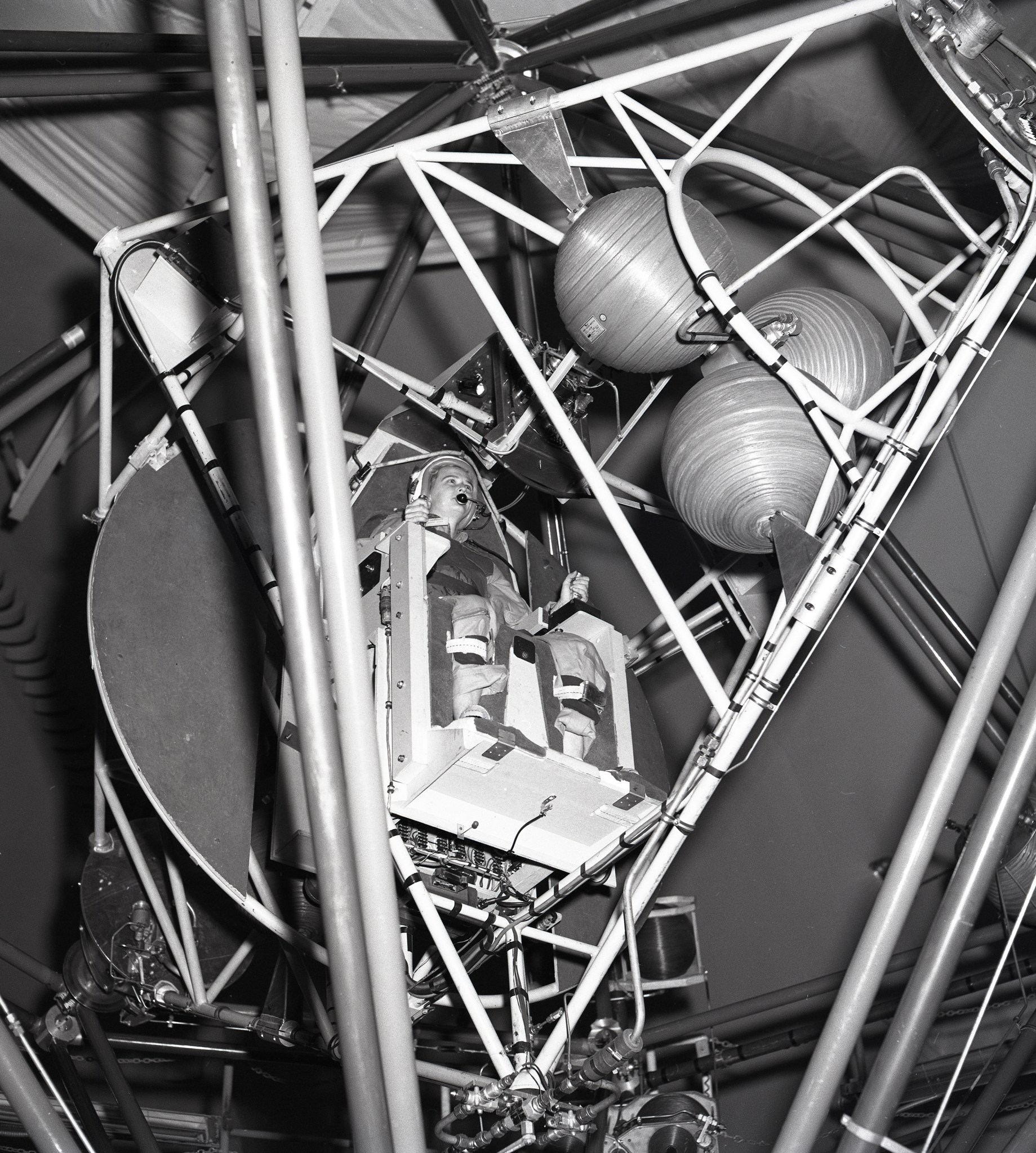 Woman sitting in gimbal rig.