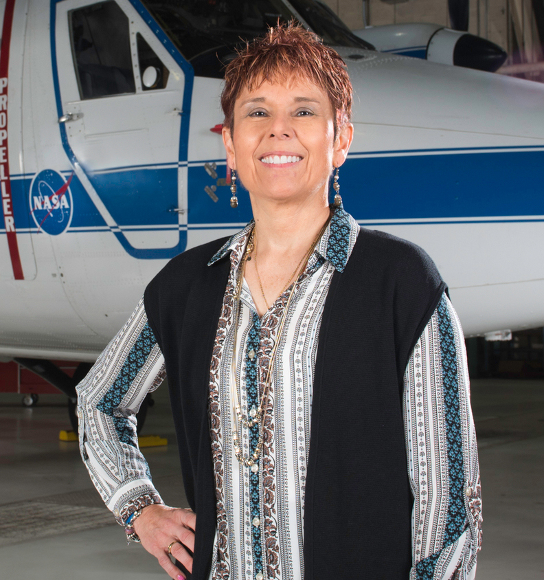 Marla Perez-Davis in front of aircraft.