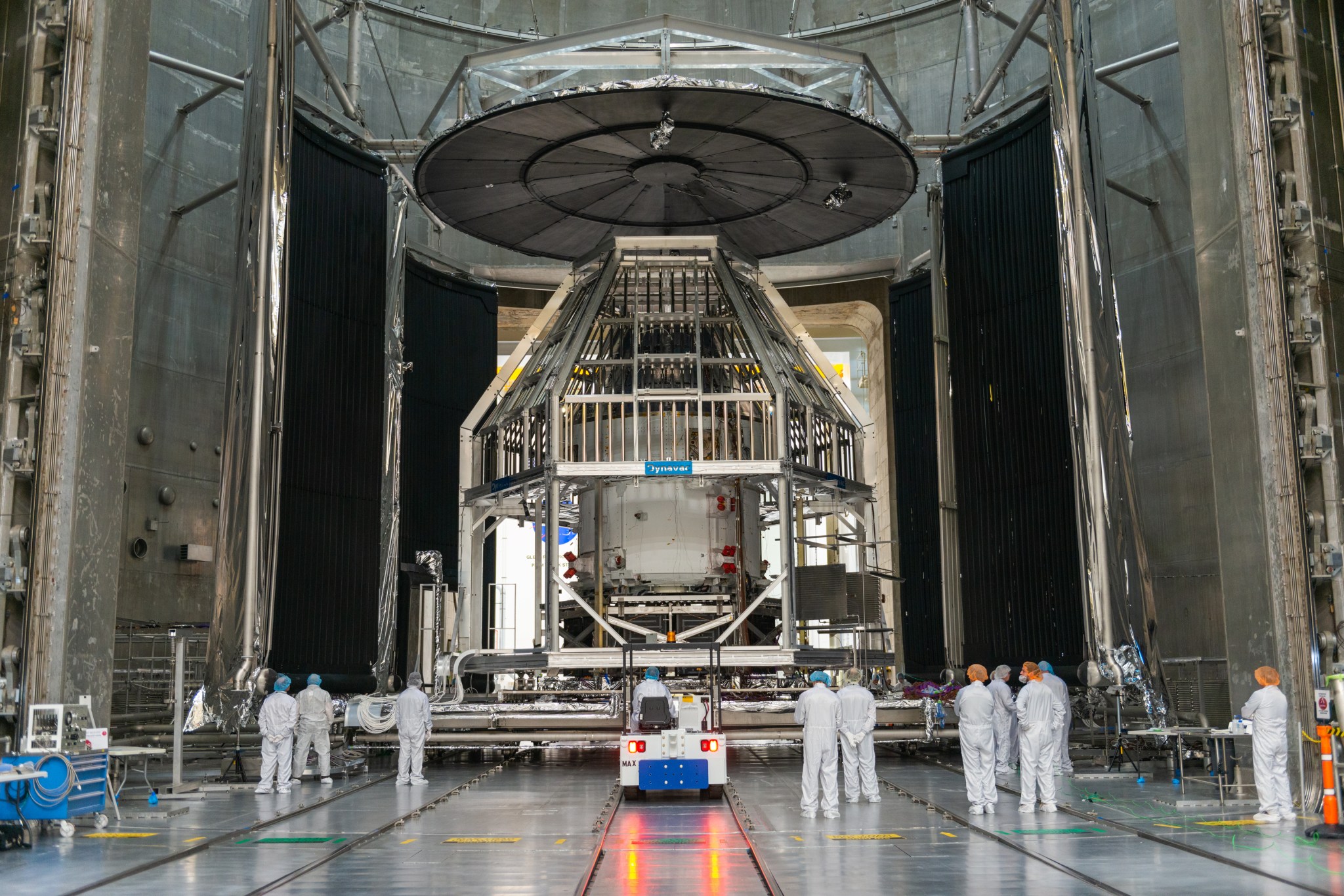 Space hardware installation in large vacuum chamber.