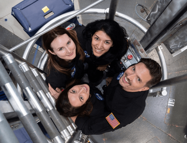 The crew of NASA's Human Exploration Research Analog Campaign 6 Mission 1 looks up from inside the habitat’s ladder well to say hello. From left to right: (top row) Lauren Cornell and Monique Garcia; (bottom row) Madelyne Willis and Christopher Roberts.