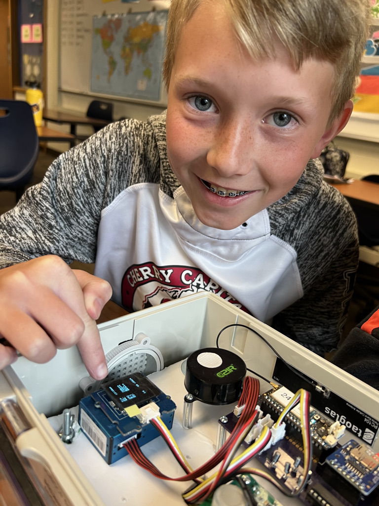 Photo of a student working with a piece of equipment