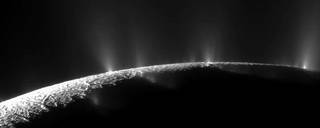The icy crust at the south pole of Enceladus exhibits large fissures that allow water from the subsurface ocean to spray into space as geysers, forming a plume of icy particles. NASAs Cassini spacecraft, which captured this imagery in 2009.