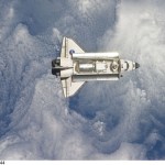 Backdropped by a blue and white part of Earth, space shuttle Discovery is featured in this image photographed by an Expedition 26 crew member as the shuttle approaches the International Space Station during STS-133 rendezvous and docking operations. Docking occurred at 2:14 p.m. (EST) on Feb. 26, 2011.