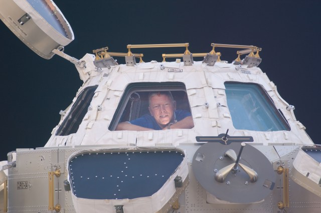 Backdropped by the blackness of space, NASA astronaut Mike Fossum, Expedition 28 flight engineer, is pictured in a window of the Cupola of the International Space Station.