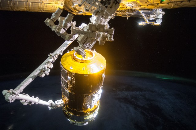 The Canadarm2 robotic arm guides Japan's Kounotori cargo craft for installation on the orbital outpost on Aug. 24, 2015.