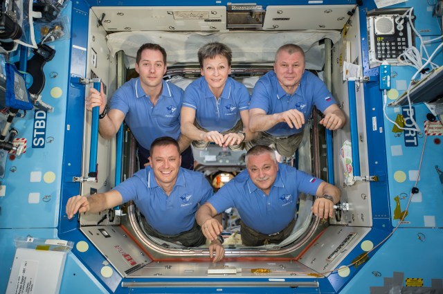 Expedition 51 crewmembers pose for an inflight portrait in the hatchway between the Unity Node 1 and Destiny U.S. Laboratory.