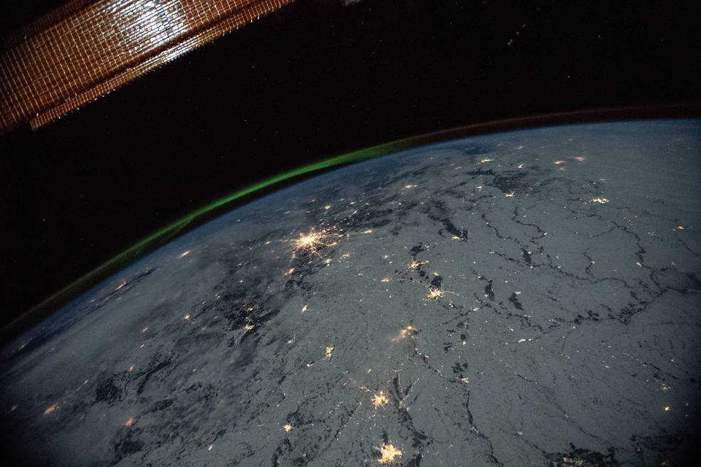 A portion of the International Space Station's solar arrays caps this nighttime view of Earth with aurora as the orbital complex orbited 258 miles above Ukraine and Russia.
