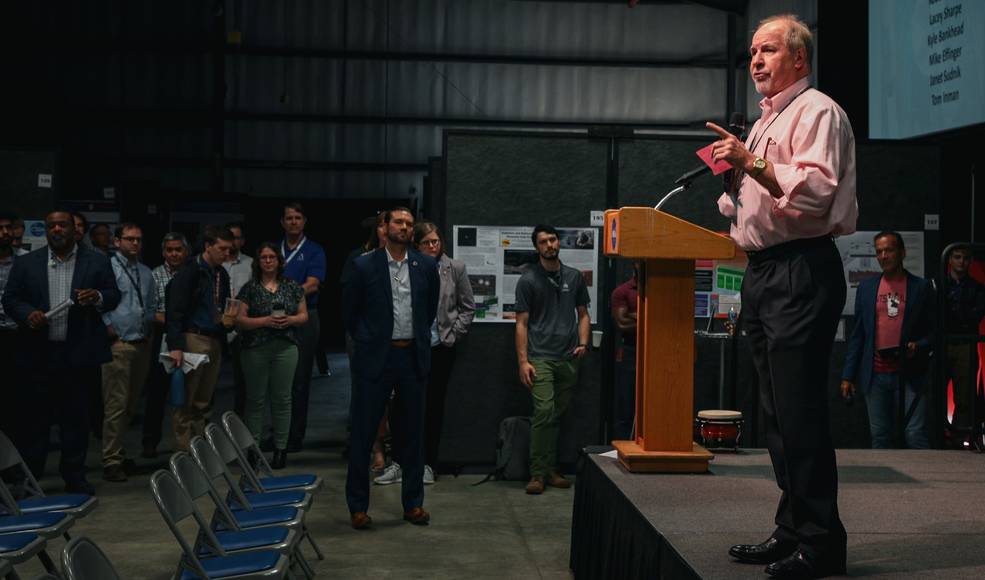 Tom Inman speaks to attendees gathered to explore the diverse range of engineering, science, and technology projects showcased at the annual Science, Technology, and Engineering Jamboree and Poster Expo held June 22.