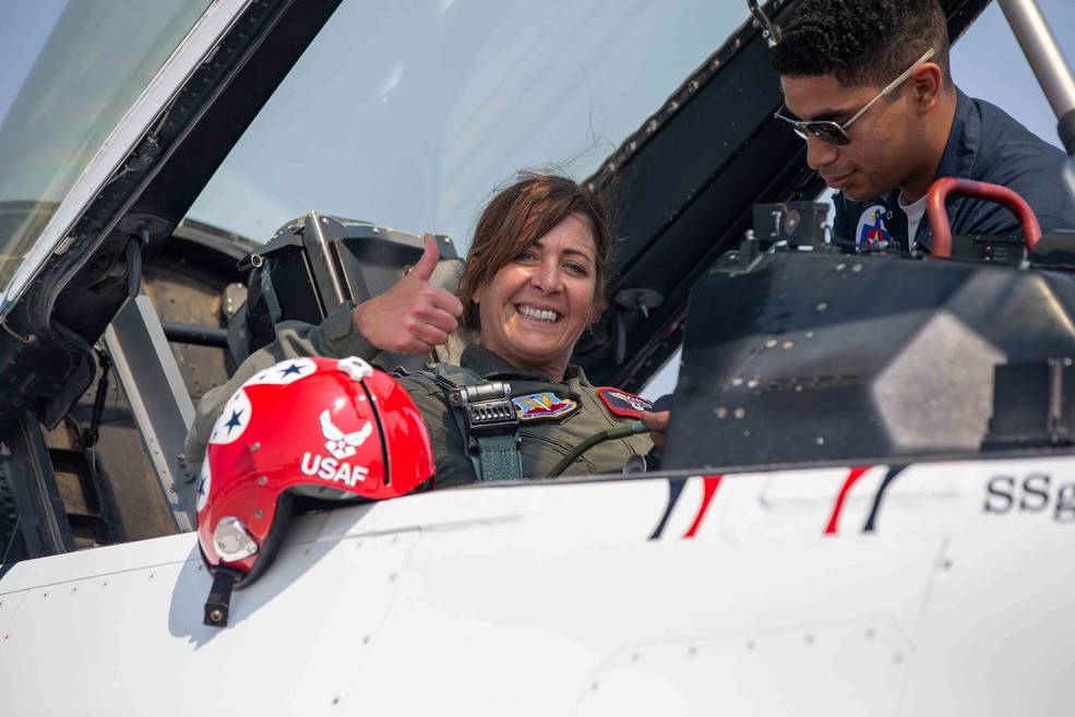 Jenifer Rayne gives a thumbs up from the cockpit of a F-16 Thunderbird.