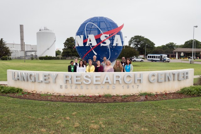 This is a photo of a group of teachers with the MODSIM Teacher Ambassadors Program posing for a photo near the entrance of NASA Langley Research Center.