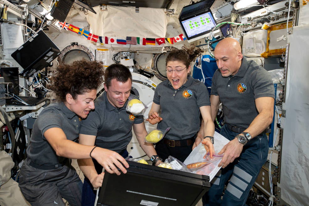 Jessica Meir, Andrew Morgan, and Christina Koch with Luca Parmitano.