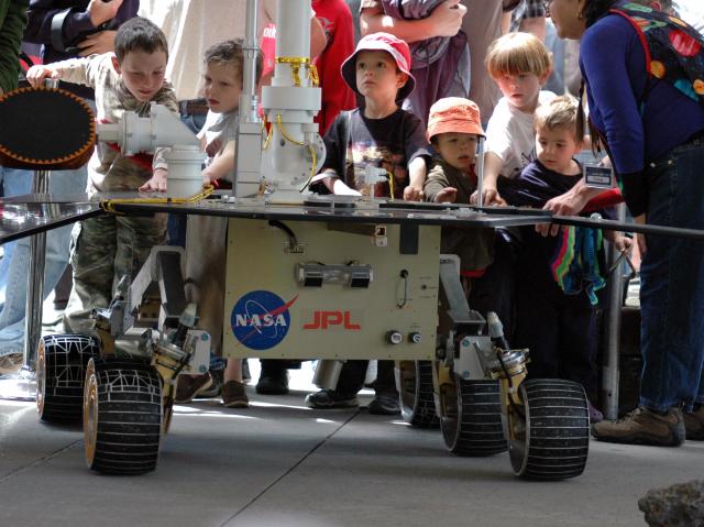 Children looking and touching NASA's Mars Exploration Rover at JPL's annual Open House.