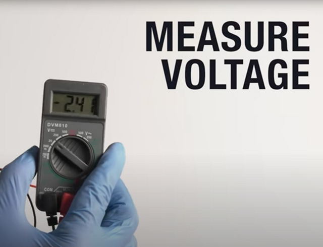 An image of someone holding a voltmeter