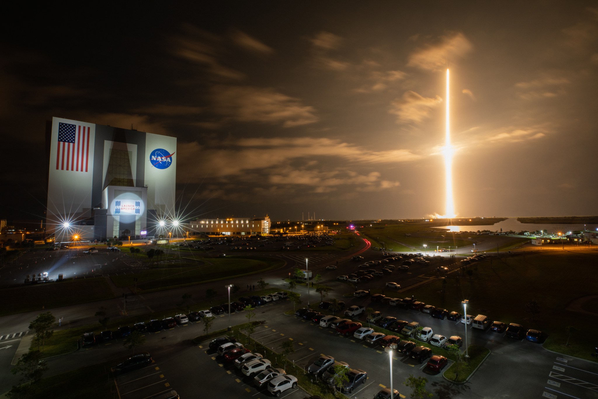 With a view of the iconic Vehicle Assembly Building at left, a SpaceX Falcon 9 rocket soars upward from Launch Complex 39A at NASA’s Kennedy Space Center in Florida.