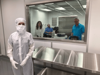 From left to right are Nicole Lunning, dressed in a cleanroom gown; Anjani Polit, mission implementation systems engineer from the University of Arizona;
