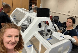 The OSIRIS-REx team practices for sample return at Johnson with a mock-up glovebox in October 2022.