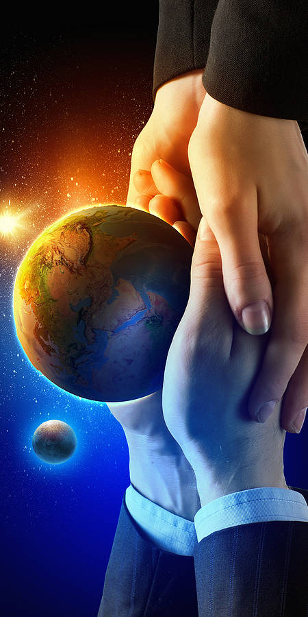 two sets of hands holding the world with a space background