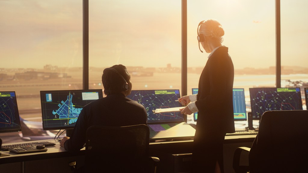 Problem Set D image showing a diverse Air Traffic Control Team Working in Modern Airport Tower at Sunset.