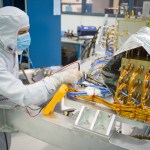 CGI: JPL engineer verifies electrical grounding of avionics systems on the Coronagraph Instrument.