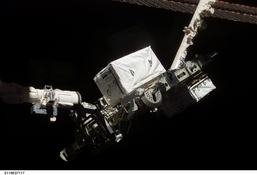 The shuttle's robotic arm handed off the ESP-3 to the station's Canadarm2 robotic arm for installation to the P3 truss on Aug. 14, 2007.