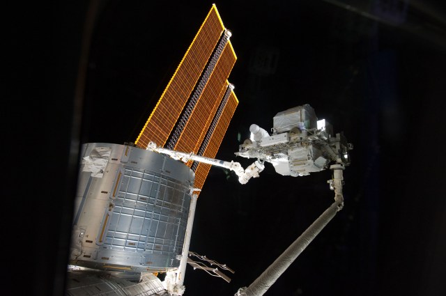 The shuttle's robotic arm handed off the ELC-3 to the station's robotic arm for installation on May 18, 2011.