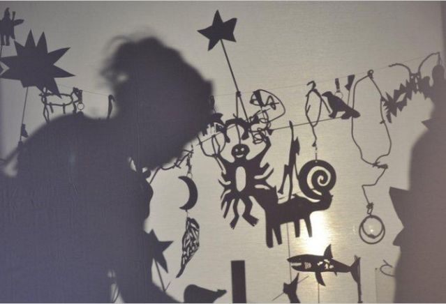 A silhouette of a child and various shapes at the ScienceWorks DaVinci's Garage Shadow Theater 