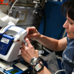 ESA (European Space Agency) astronaut Samantha Cristoforetti operates the rHEALTH One analyzer on the International Space Station in May 2022.