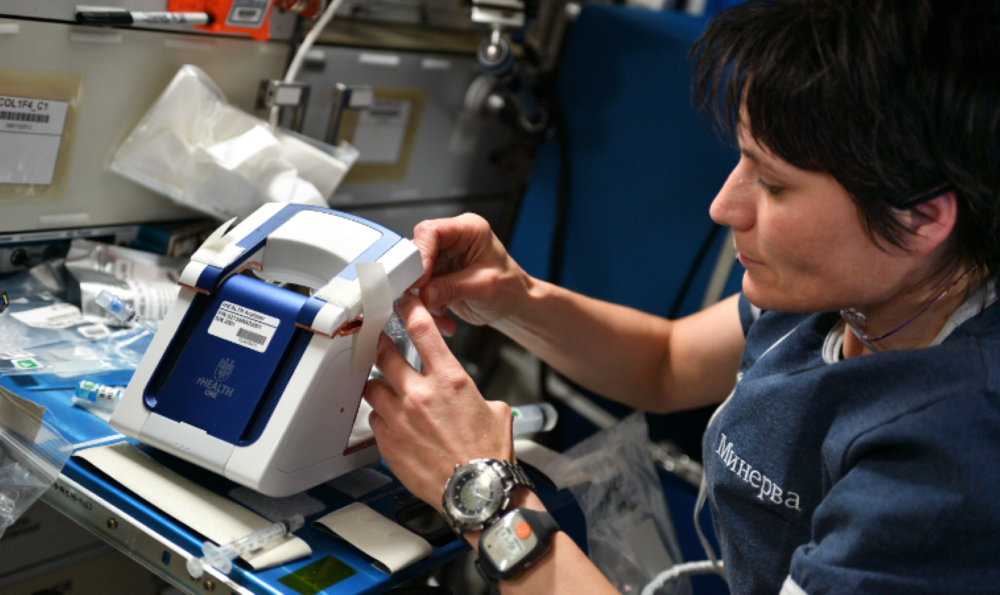 ESA (European Space Agency) astronaut Samantha Cristoforetti operates the rHEALTH One analyzer on the International Space Station in May 2022.