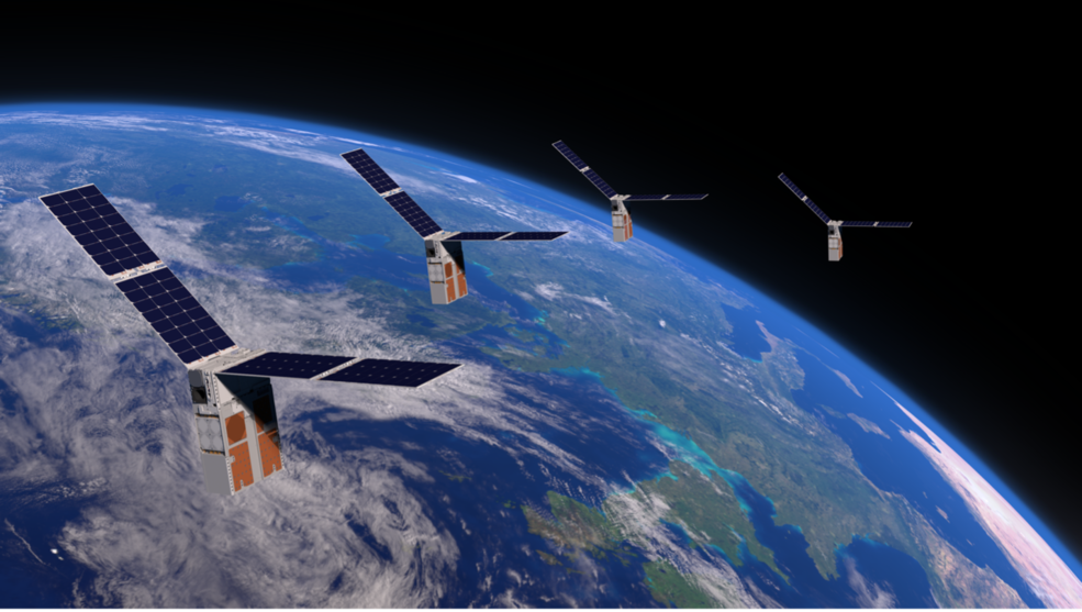 An illustration of a swarm of four satellites -- rectangular units with solar panels extending at the top from both sides -- with Earth in the background.
