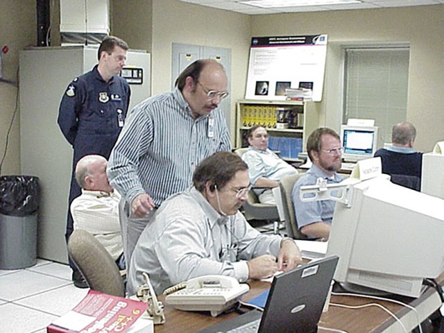 NASA engineers and scientists coordinating worldwide meteor data collection in 2001.